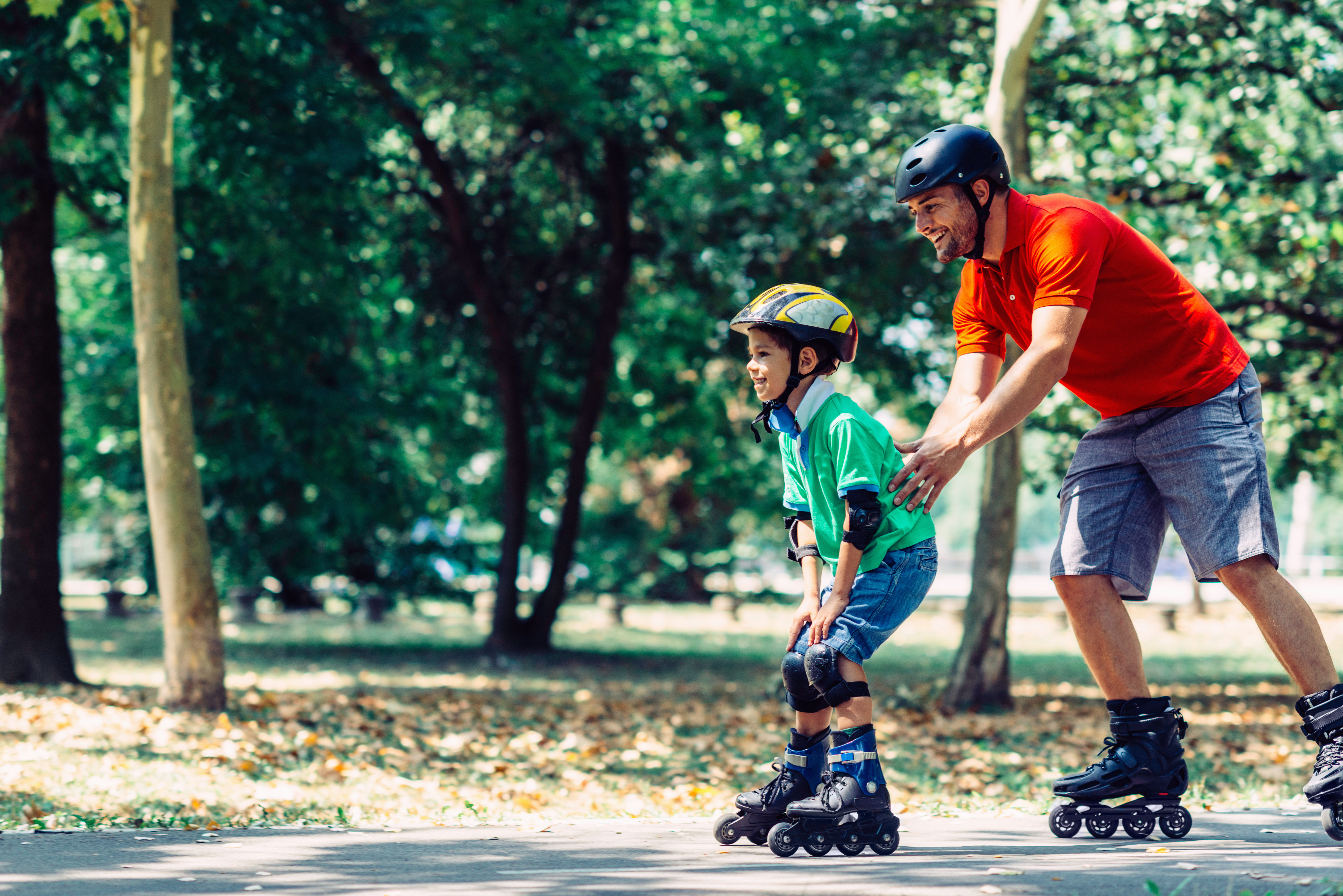 Little boy learning roller skating in the park