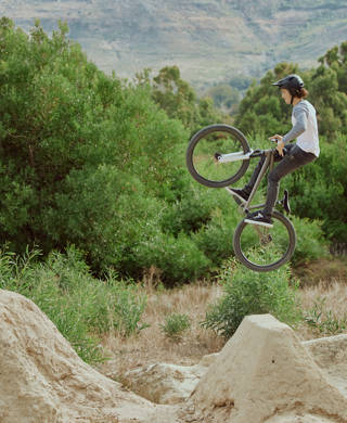 Cycling jump, sports or mountain bike man with air trick for fun, exercise or training for speed travel race. Dirt ramp, bicycle nature flight or extreme athlete with freestyle action
