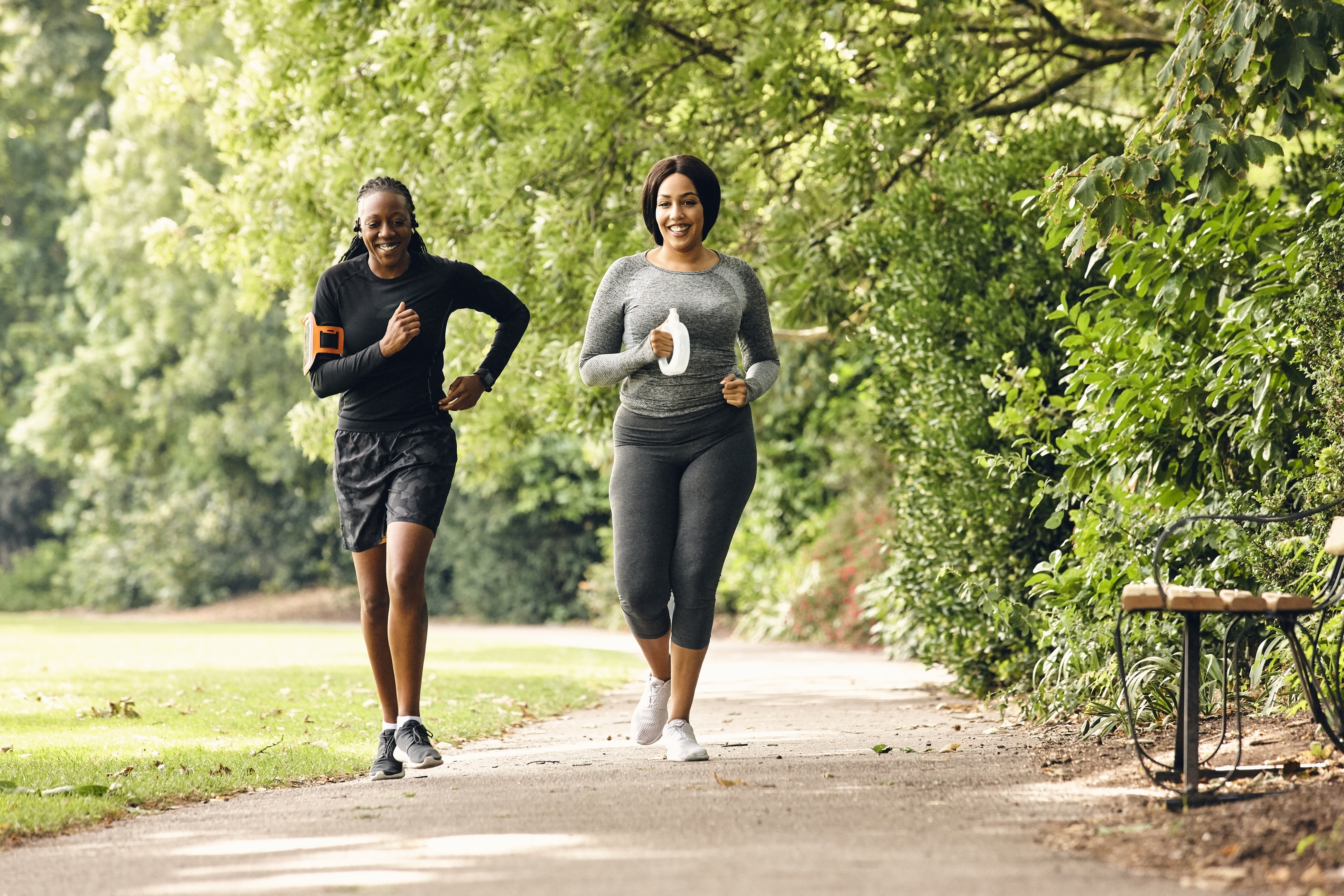 Two healthy women running at morning in the park.